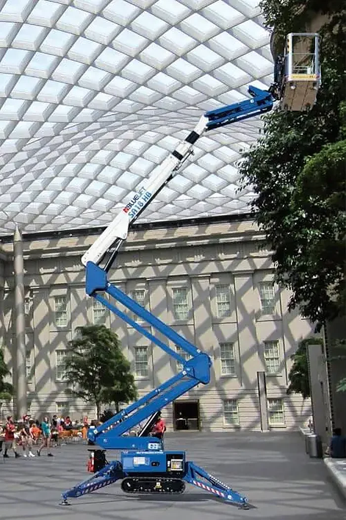 Ruthmann Bluelift SA18HB spider lift set up on outriggers with the boom extended